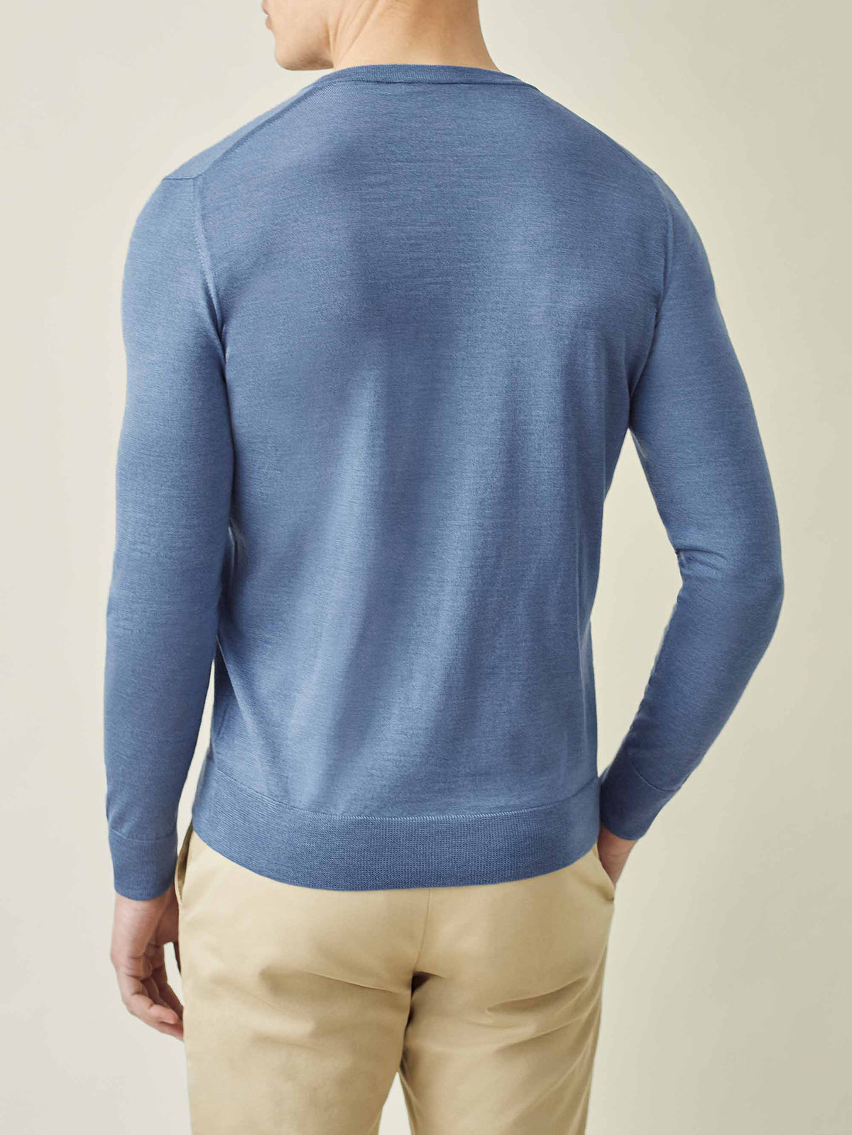 Back view of a model wearing the Luca Faloni Silk-Cashmere V-Neck in Azure, showcasing the tailored fit.