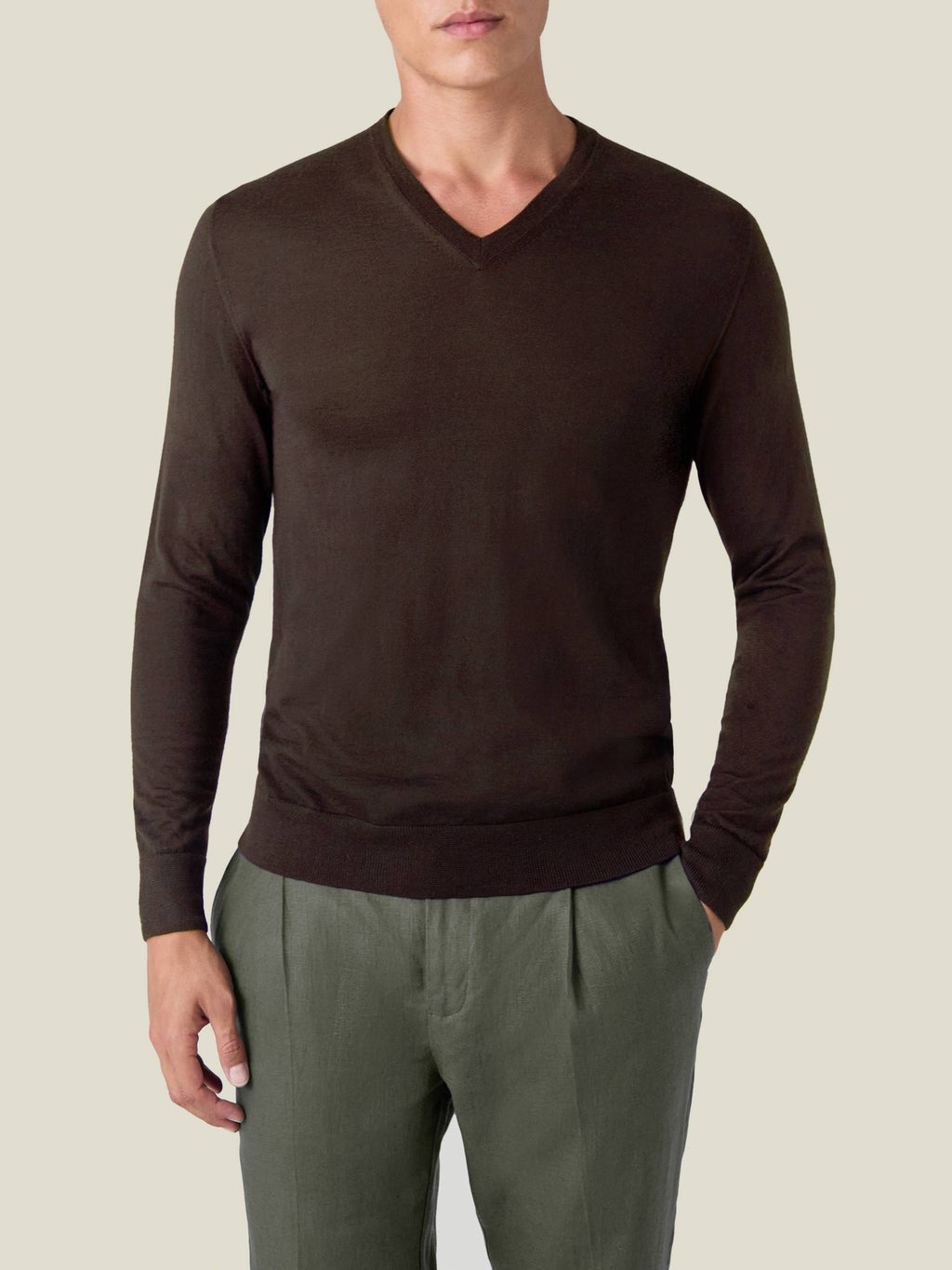 Front view of a model wearing the Silk-Cashmere V Neck in Chocolate Brown with olive green trousers.