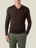 Front view of a model wearing the Silk-Cashmere V Neck in Chocolate Brown with olive green trousers.