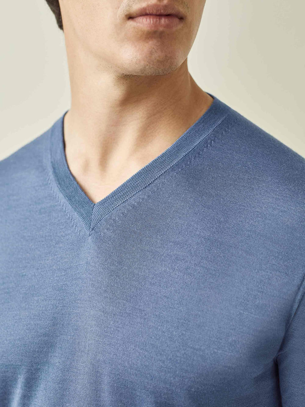 A detailed close-up of the ribbed V-neck on the men's Azure Blue Silk-Cashmere sweater.