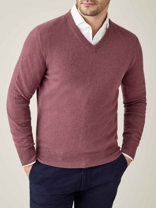 Model wears the Luca Faloni Cashmere V-Neck in Desert Rose, layered over a white shirt and paired with navy trousers.