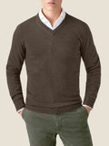 Front view of a model wearing the Chocolate Brown Cashmere V Neck Jumper, layered over a white shirt with green trousers.