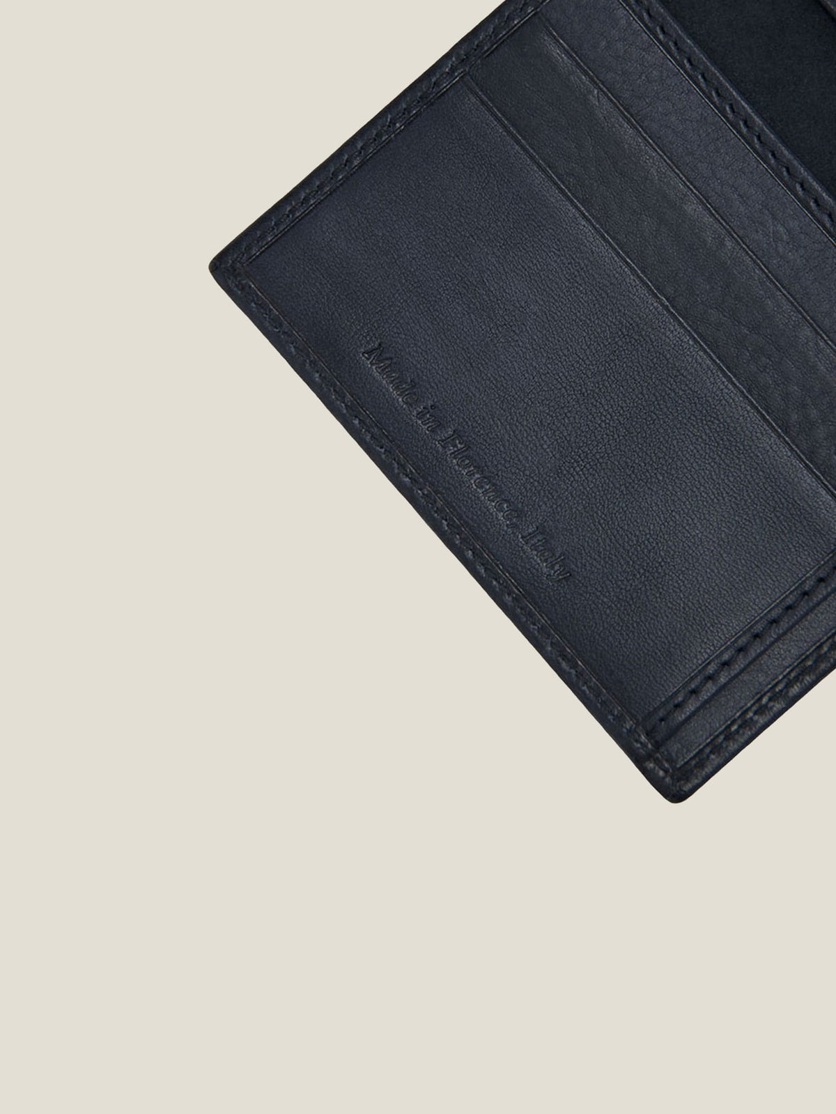 A close-up of the ink blue leather Bifold Cardholder's interior, highlighting the 'Made in Italy' embossment.