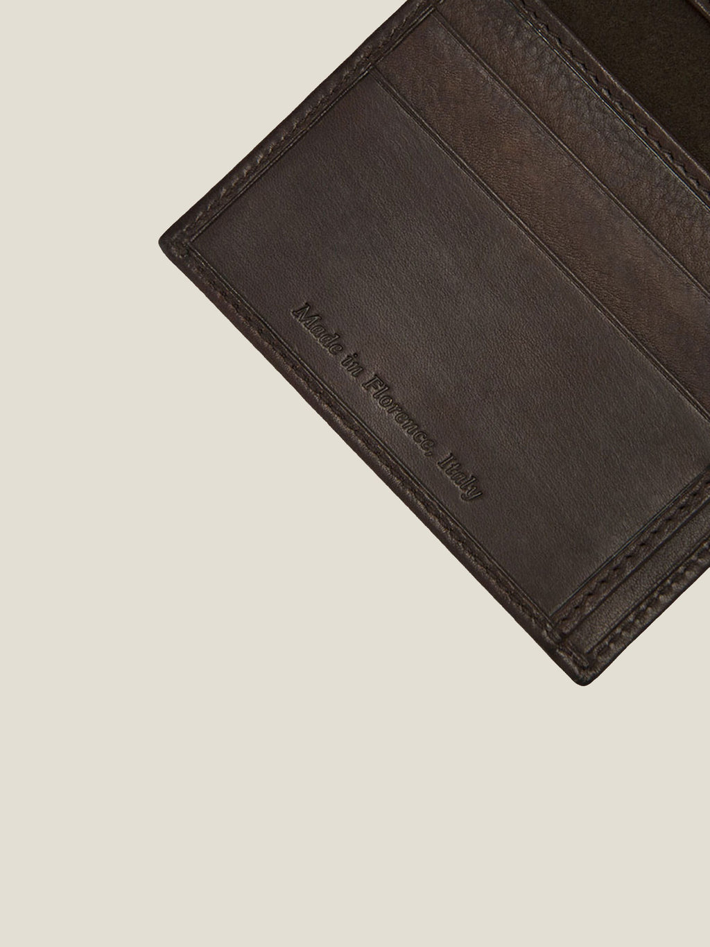 Close-up detail of the 'Made in Florence, Italy' stamp on the Luca Faloni Chocolate Brown Leather Bifold Cardholder.