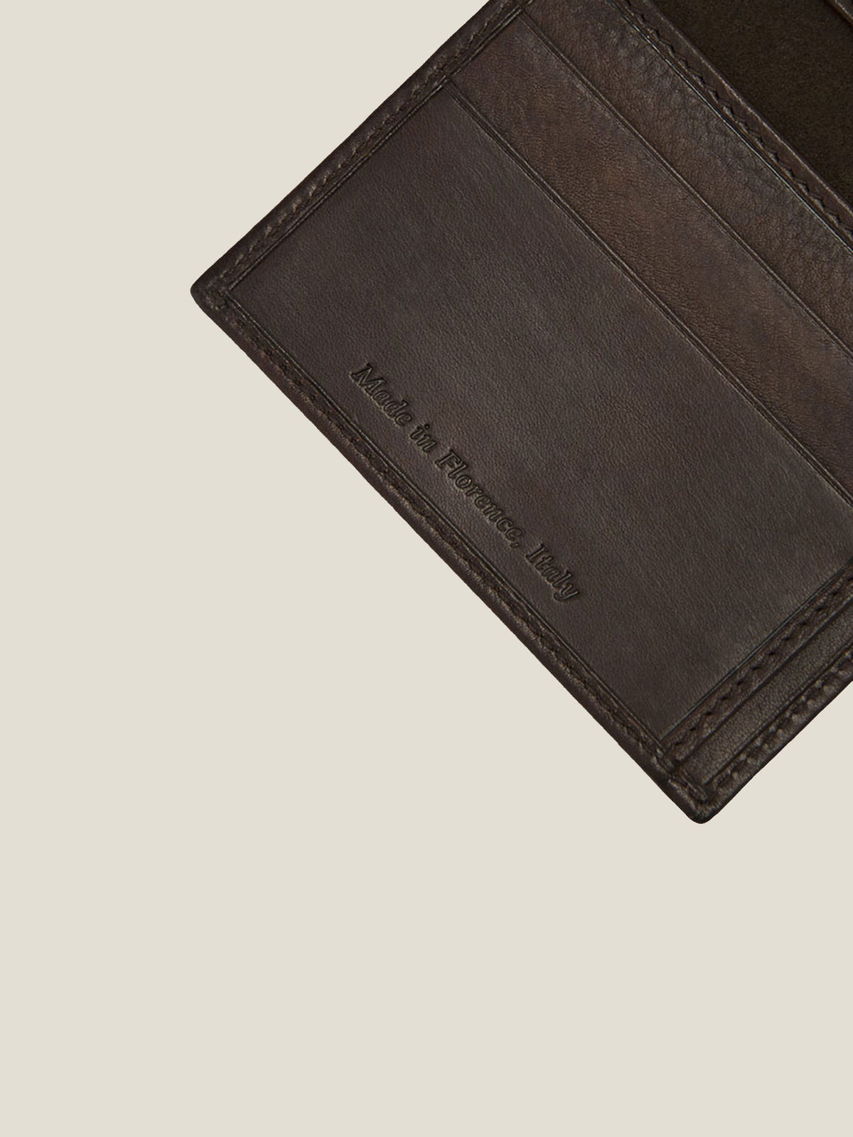 Close-up detail of the 'Made in Florence, Italy' stamp on the Luca Faloni Chocolate Brown Leather Bifold Cardholder.