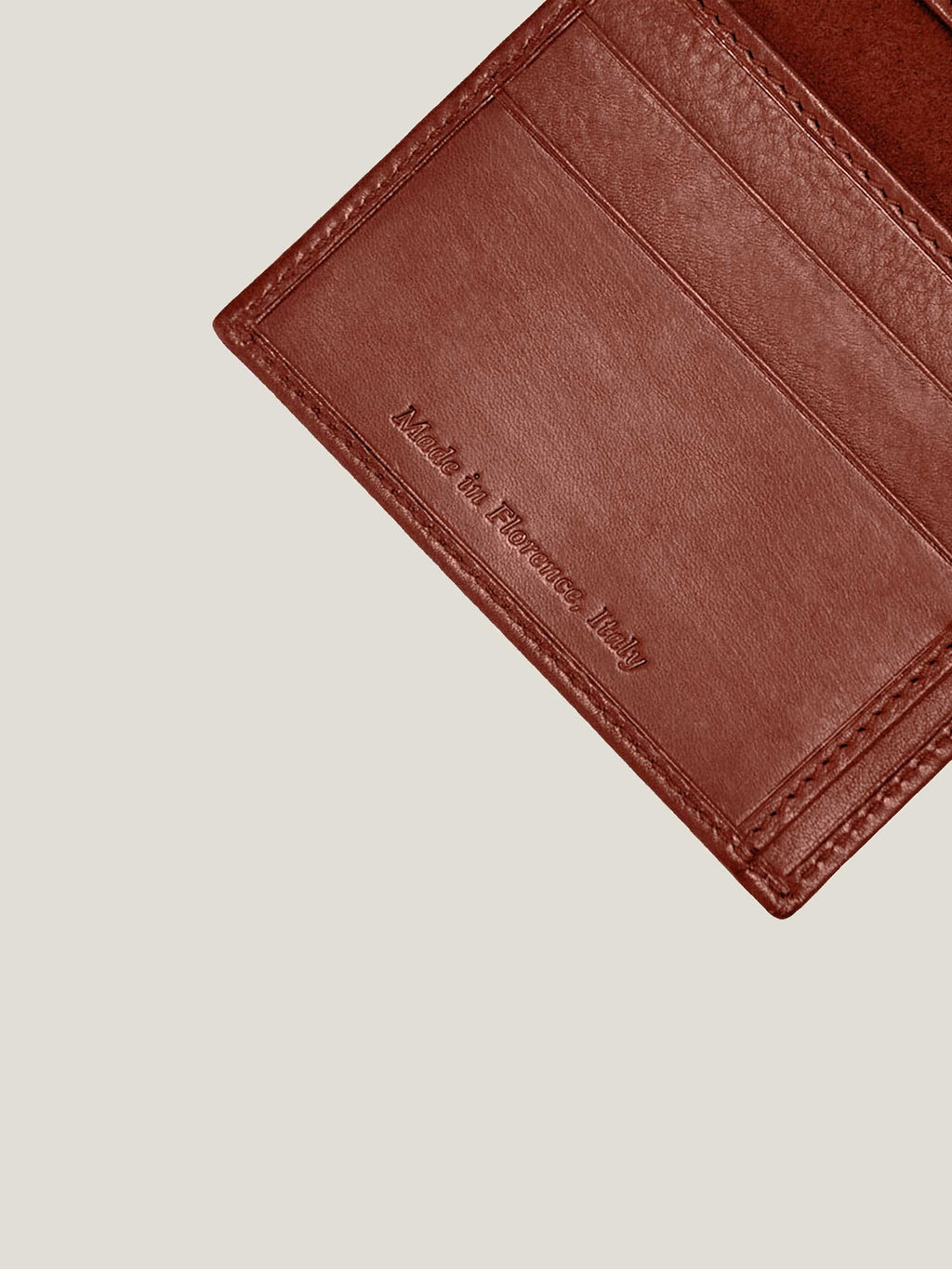 Close-up of the 'Made in Florence, Italy' embossing inside the Caramel Brown Leather Bifold Cardholder.