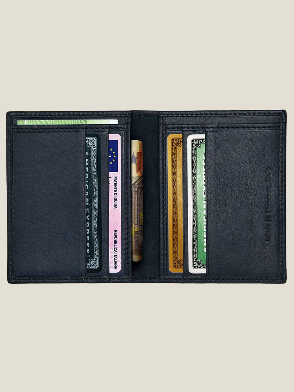 Interior of the Ink Blue Leather Bifold Cardholder, open to show its card slots and sleeves filled with cards and cash.