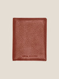 The Luca Faloni Bifold Cardholder in Caramel Brown leather. The wallet is closed, showing the textured front and brand logo.