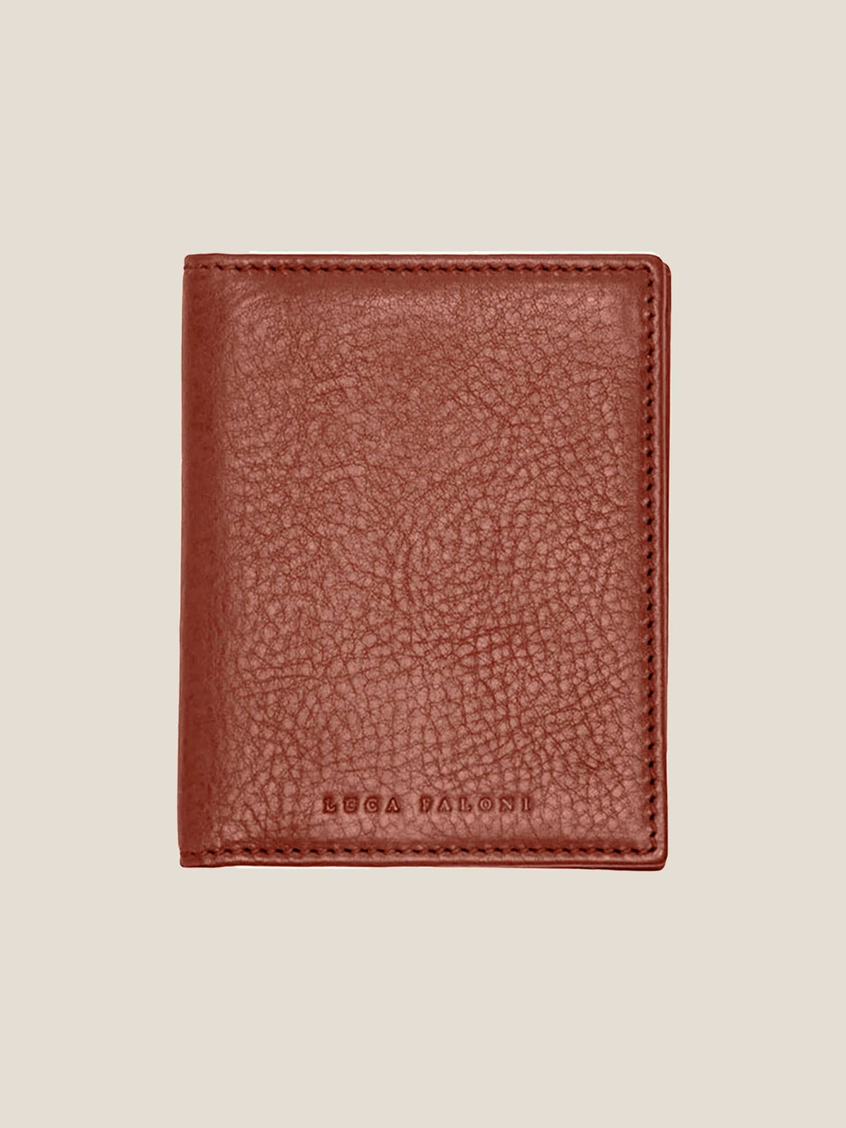 The Luca Faloni Bifold Cardholder in Caramel Brown leather. The wallet is closed, showing the textured front and brand logo.