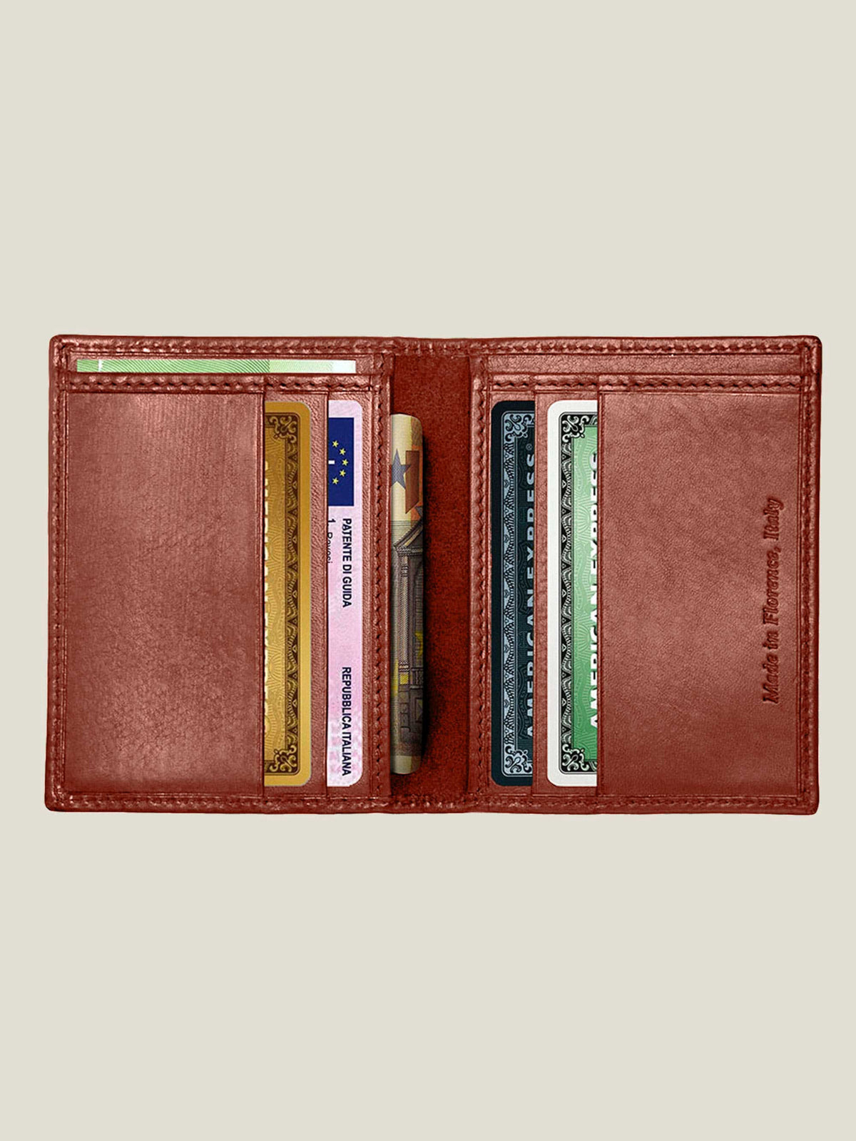 Open Caramel Brown Leather Bifold Cardholder showing interior slots filled with cards and bills.