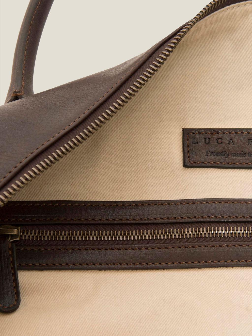 Detailed view of the interior of the Weekender bag in chocolate brown leather, showing the internal zip pocket and lining.