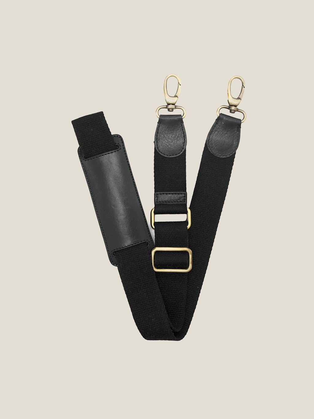 Detachable shoulder strap for the black leather Weekender bag, with leather comfort pad and adjustable gold-tone hardware.