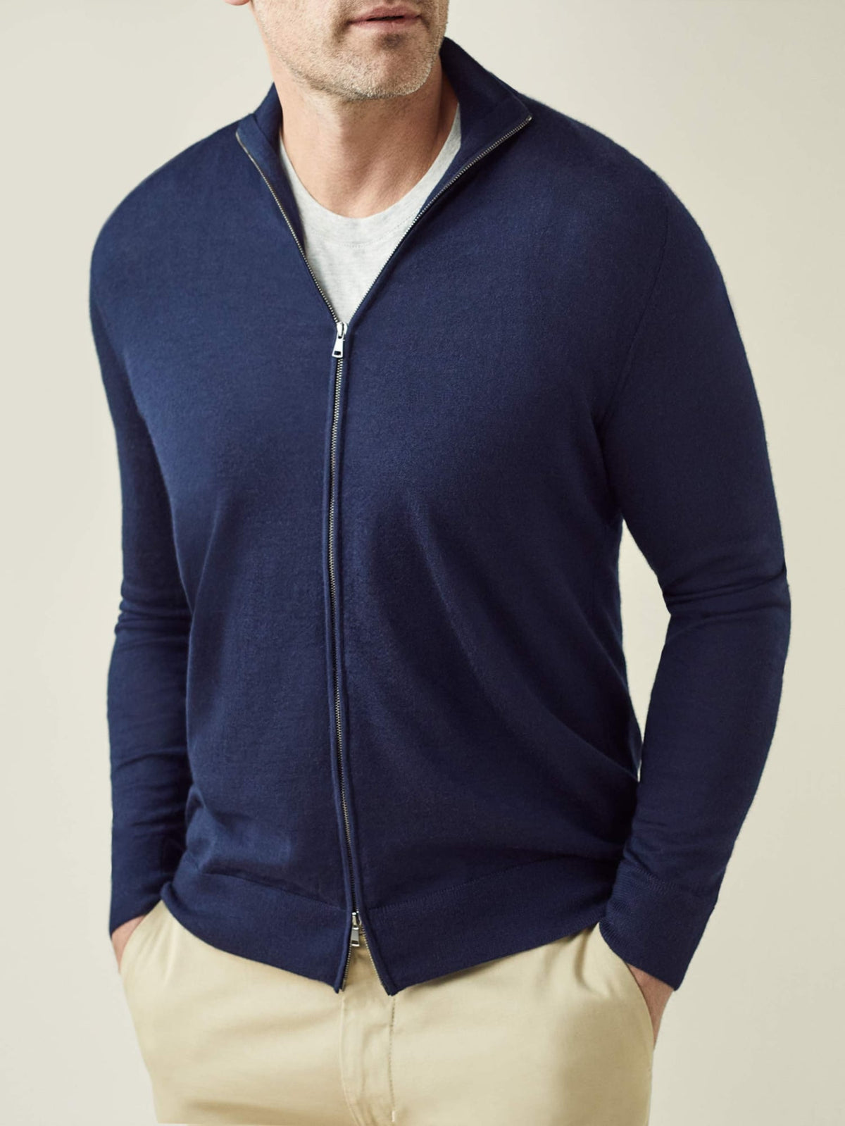 A front view of a man wearing the Luca Faloni Silk-Cashmere Zip Cardigan in navy blue over a t-shirt.