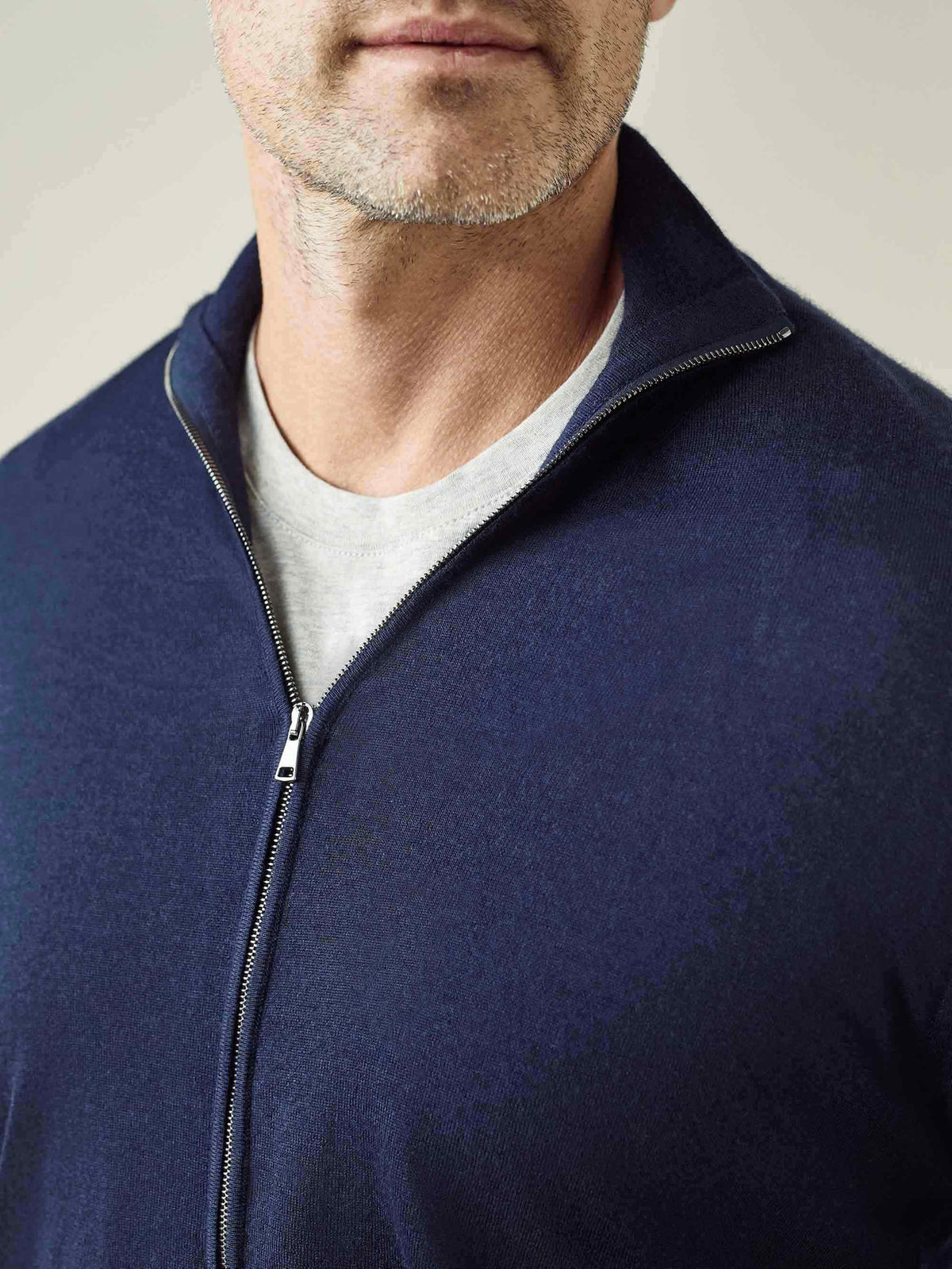 A close-up of the Navy Blue Silk-Cashmere Zip Cardigan, highlighting the funnel collar, zip detail, and fine-knit texture.