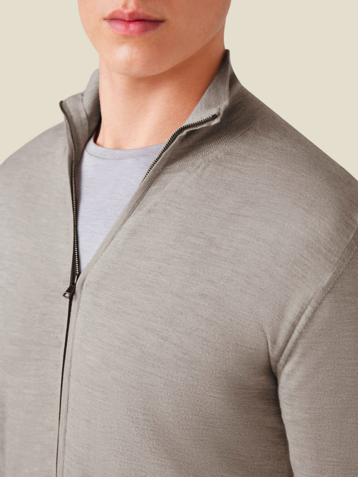 A close-up of a model wearing the Nocciola Brown Silk-Cashmere Zip Cardigan, highlighting the funnel collar and zip detail.