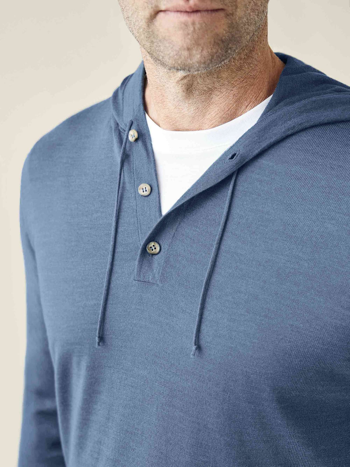 Close-up of a man wearing the Azure Silk-Cashmere Hoodie, highlighting the three-button placket and soft texture.