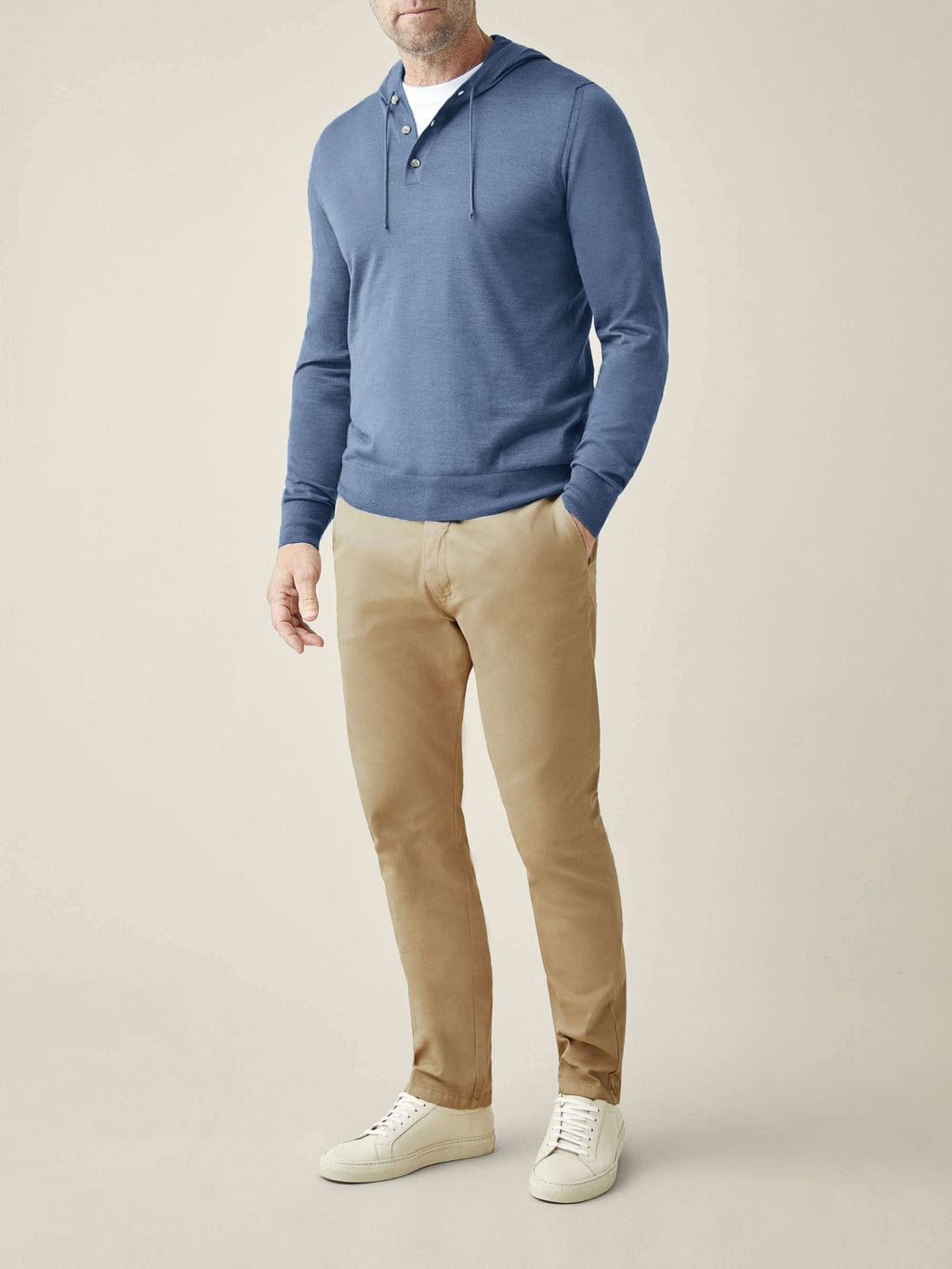 A full outfit view of a man wearing the Azure Silk-Cashmere Hoodie with khaki chinos and white sneakers.