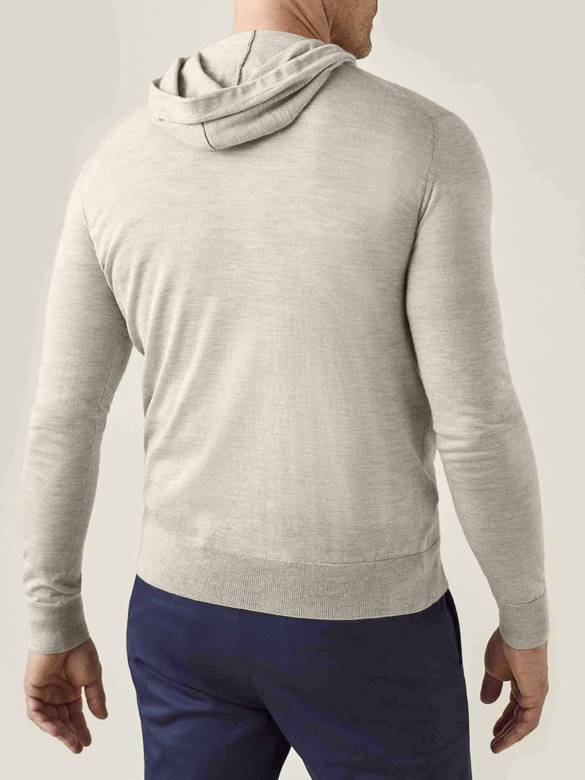 Back view of a man wearing the Oatmeal Silk-Cashmere Hoodie, showcasing the garment's drape and hood.