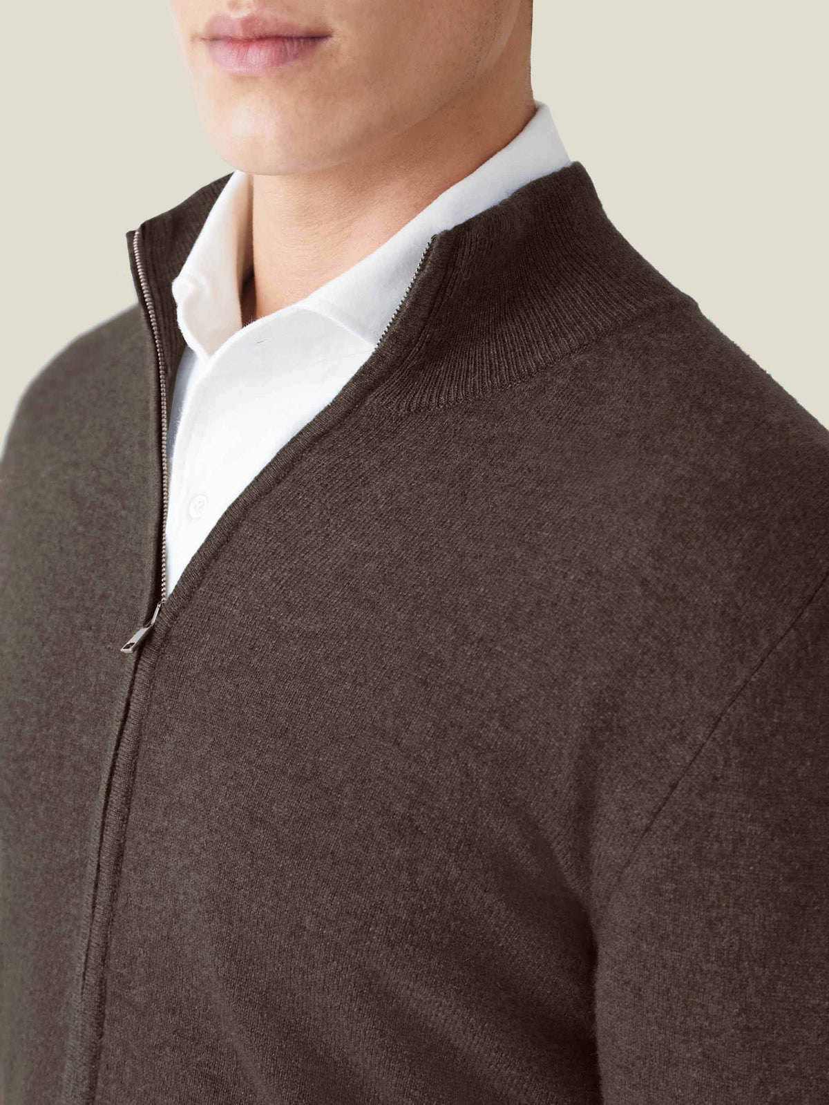 Man wearing the Chocolate Brown Cashmere Zip Cardigan. Close-up on the ribbed collar, zipper, and soft cashmere fabric.