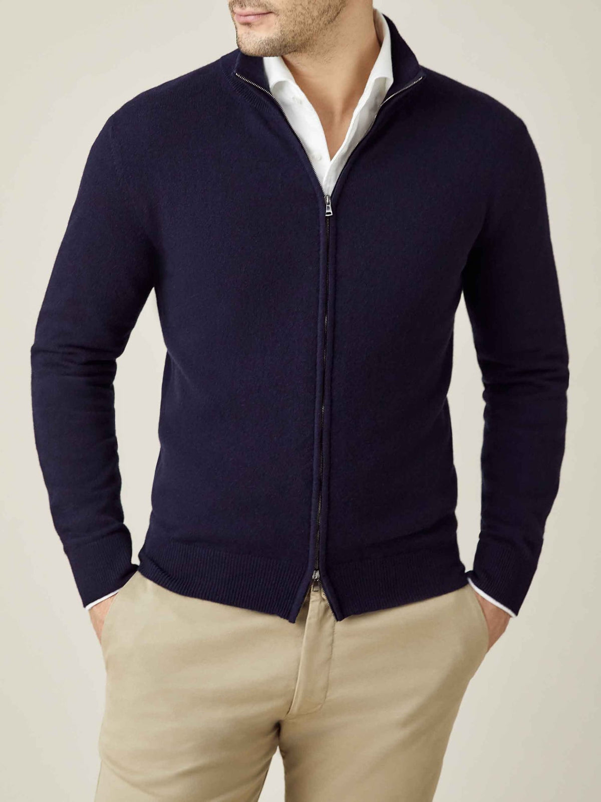 Front view of a man wearing the Midnight Blue Cashmere Zip Cardigan layered over a white collared shirt.