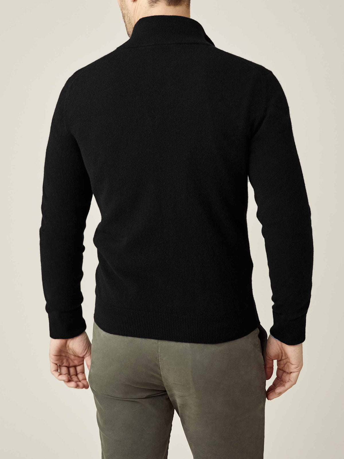 Back view of a model wearing the Luca Faloni Black Cashmere Zip Cardigan, highlighting its clean silhouette and fit.