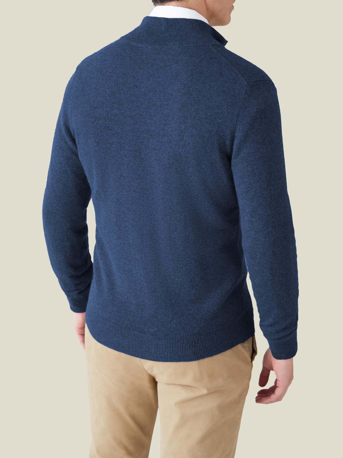 Rear view of a model wearing the Atlantic Blue Cashmere Zip Cardigan, showing the fit and drape of the knit.