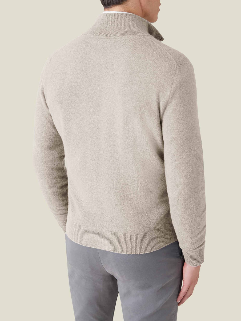 Back view of a model wearing the Almond Cashmere Zip Cardigan.