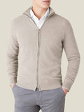 Model wears the Luca Faloni almond cashmere zip cardigan, layered over a white shirt and paired with grey trousers.