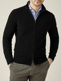 Front view of a model wearing the Luca Faloni Black Cashmere Zip Cardigan over a light blue shirt and grey trousers.