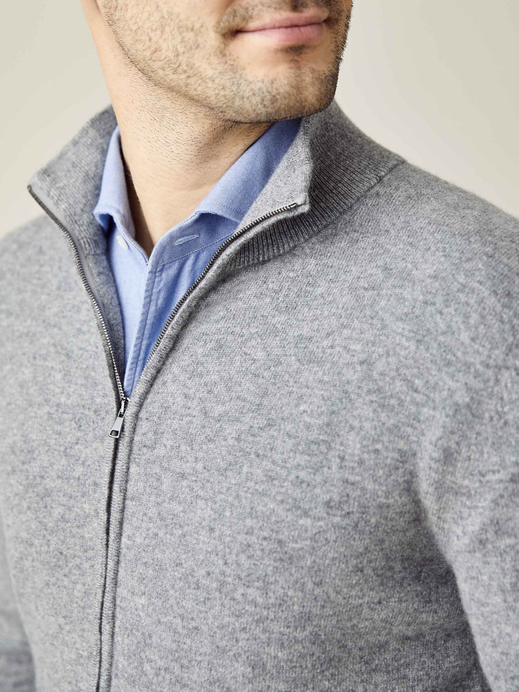 Close-up of a model wearing the Dolomiti Grey Cashmere Zip Cardigan, highlighting the funnel neck and zipper detail.