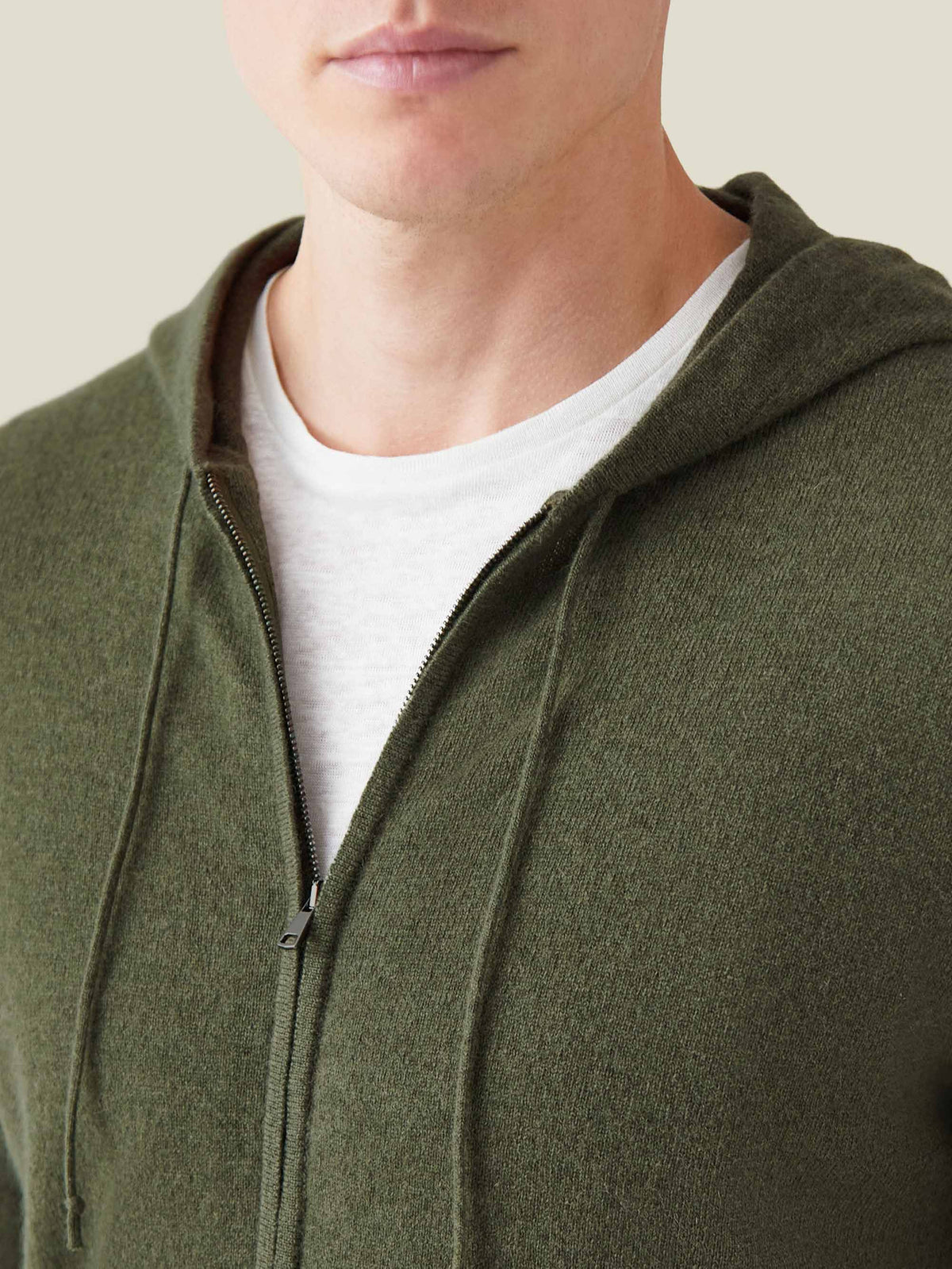 Close-up of a man wearing the Luca Faloni hunting green cashmere zip hoodie, highlighting the soft knit and zip detail.