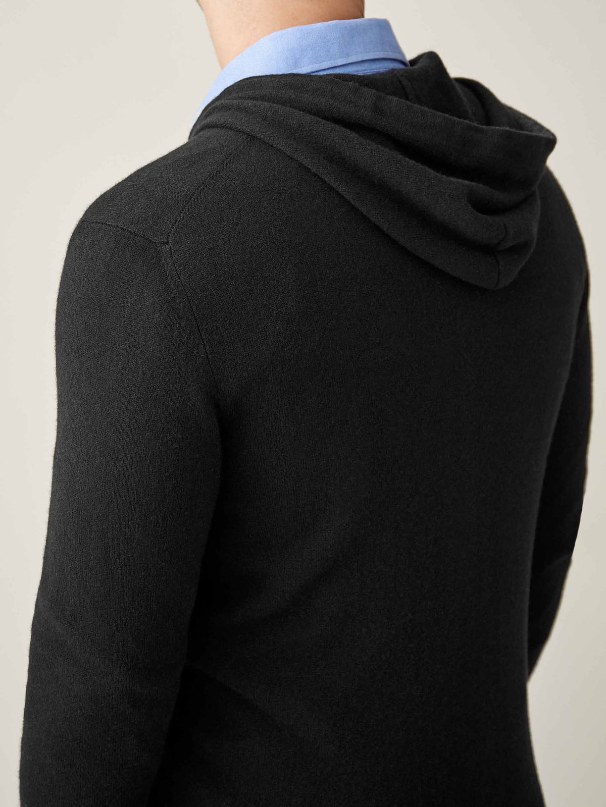 Close-up back view of the Luca Faloni Black Cashmere Zip Hoodie, showcasing the hood and fine knit texture.