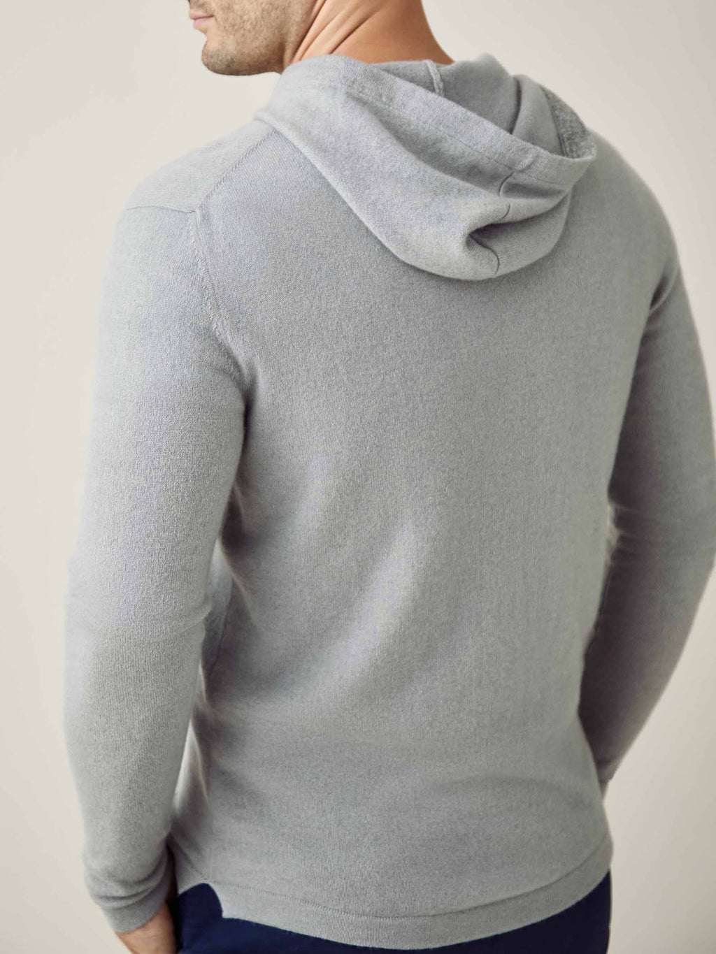 Model wears the Luca Faloni Misty Grey Cashmere Zip Hoodie, seen from the back to showcase the fit and hood detail.