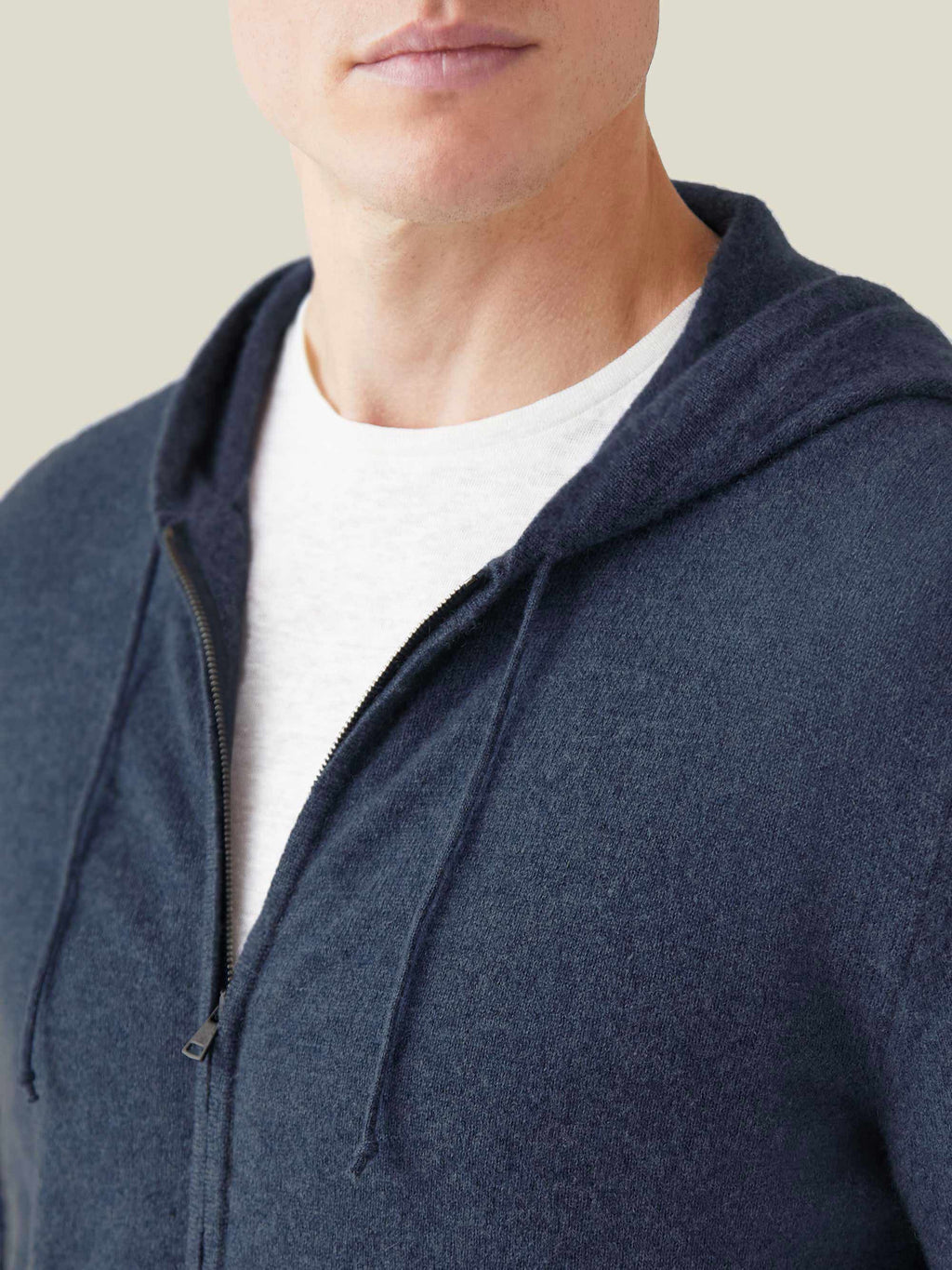A close-up of a model wearing the Atlantic Blue Cashmere Zip Hoodie, showing the soft fabric texture and the zipper detail.
