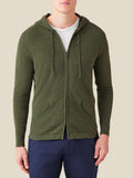 Front view of a man wearing the Luca Faloni Cashmere Zip Hoodie in Hunting Green with a white t-shirt and navy trousers.