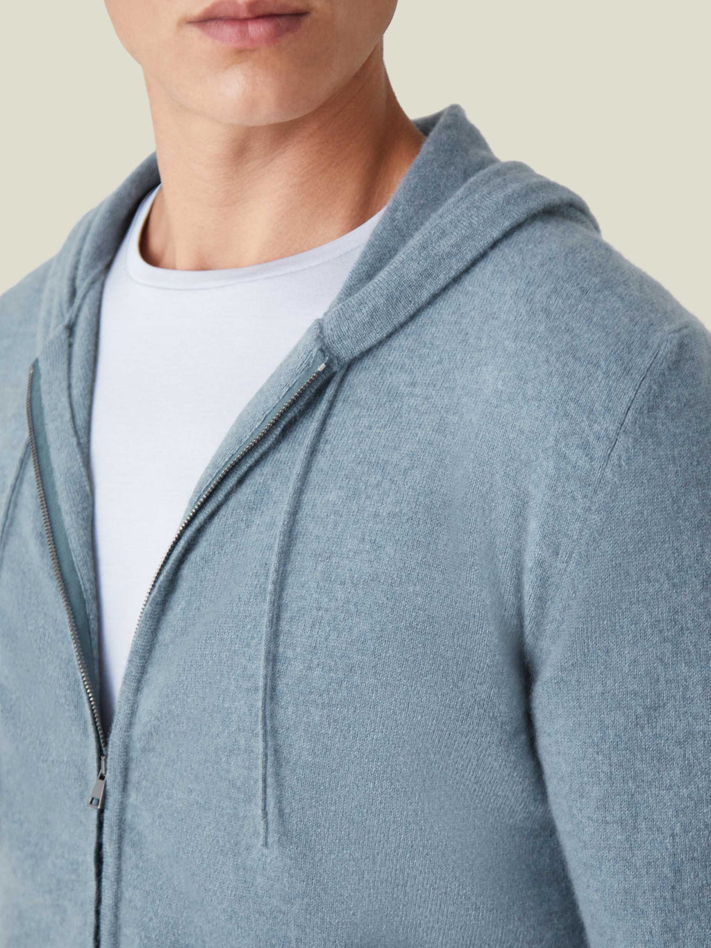 Close-up of a man wearing the French Blue Cashmere Zip Hoodie, showcasing the soft fabric texture and zip closure.