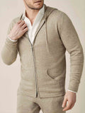 A model wears the camel beige cashmere zip hoodie and matching joggers, layered over a classic white shirt.