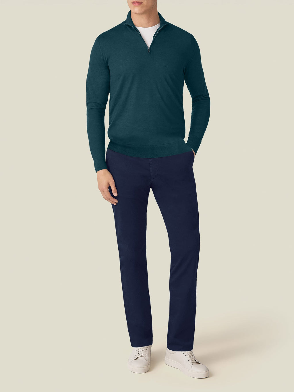 A model from the front wearing the Forest Green Silk-Cashmere Zip-up, paired with navy trousers and white trainers.