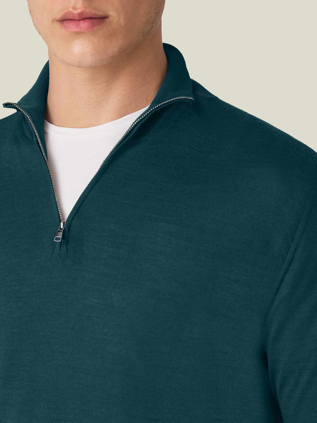 A close-up of a man wearing the Forest Green Silk-Cashmere Zip-up, showing the funnel collar and zip detail.
