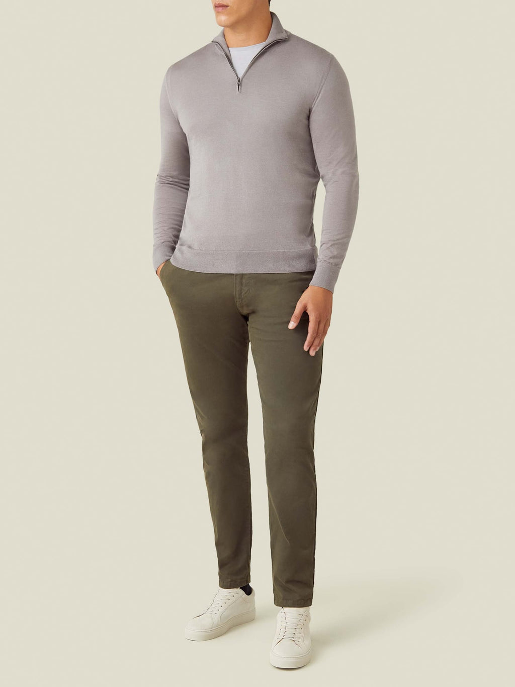 Full view of a model styling the Silk-Cashmere Zip-up in Nocciola Brown with olive chinos and white sneakers.