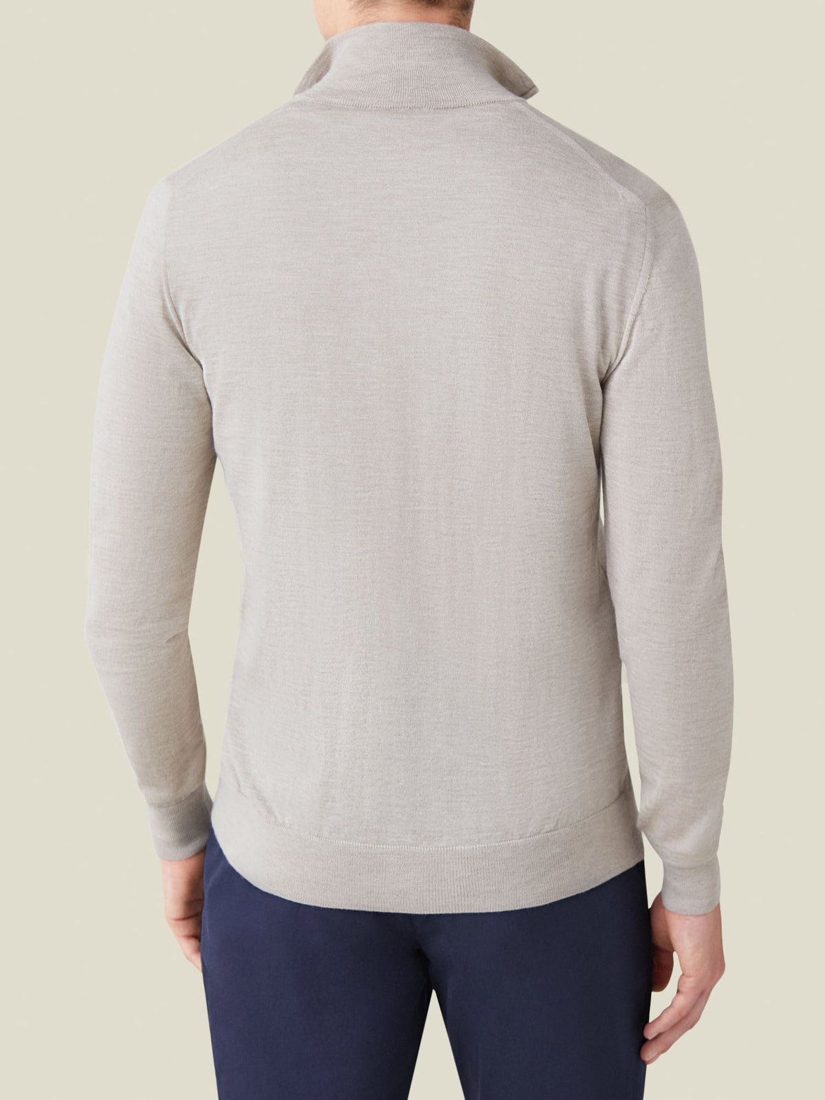 Back view of a man wearing the Luca Faloni Silk-Cashmere Zip-up in Oatmeal, styled with navy trousers.