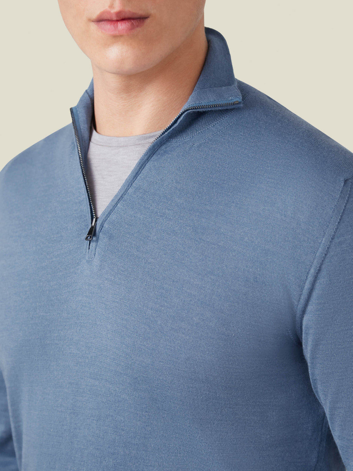 Close-up of a man wearing the Azure Silk-Cashmere Zip-Up, highlighting the fine knit, collar, and premium zipper detail.