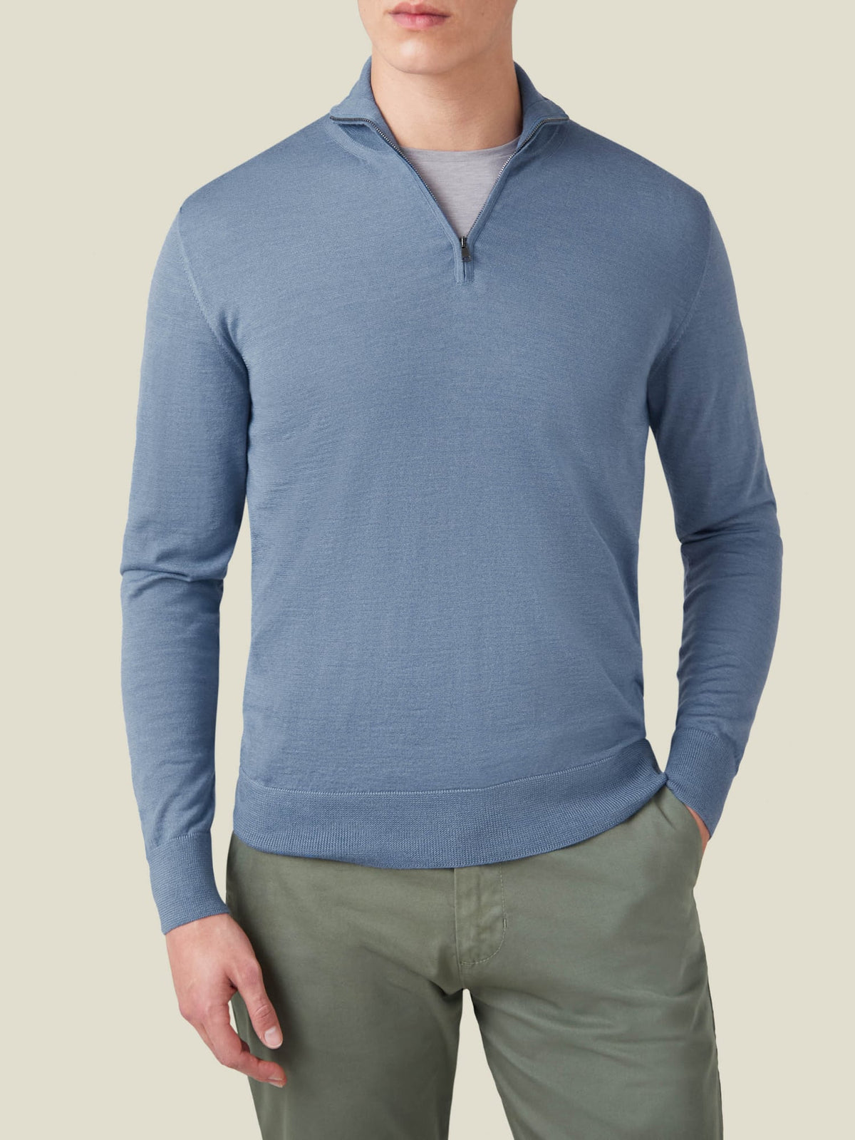 Front view of a model in Luca Faloni's Azure Silk-Cashmere Zip-up, styled with green chinos and a grey t-shirt.