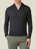 A man wearing the Luca Faloni Silk-Cashmere Zip-up in Charcoal Grey, layered over a t-shirt and paired with green chinos.
