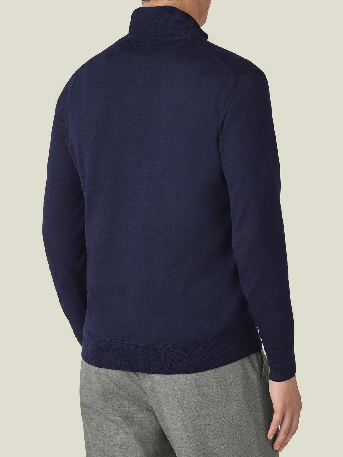 Rear view of a man wearing the navy blue Silk-Cashmere Zip-up, showcasing its fit and ribbed hem.