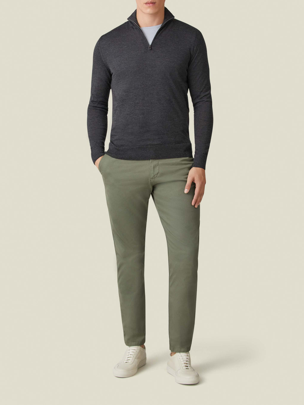 Front view of a model wearing the Charcoal Grey Silk-Cashmere Zip-up with olive green chinos and white sneakers.