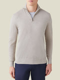 Front view of a man wearing the oatmeal silk-cashmere zip-up jumper, layered over a light grey t-shirt.