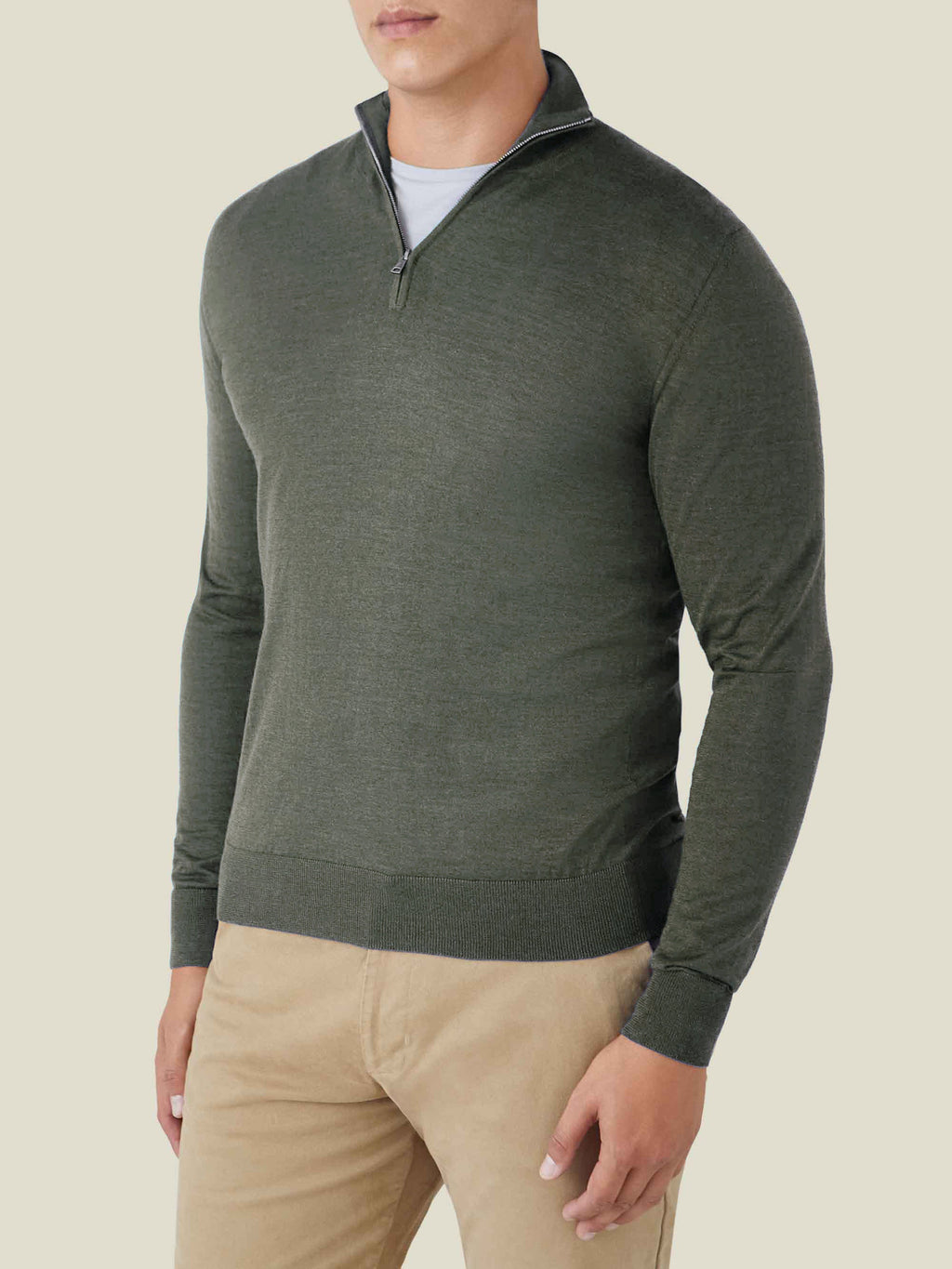 A front view of a model wearing the Luca Faloni Moss Green Silk-Cashmere Zip-up with tan trousers.