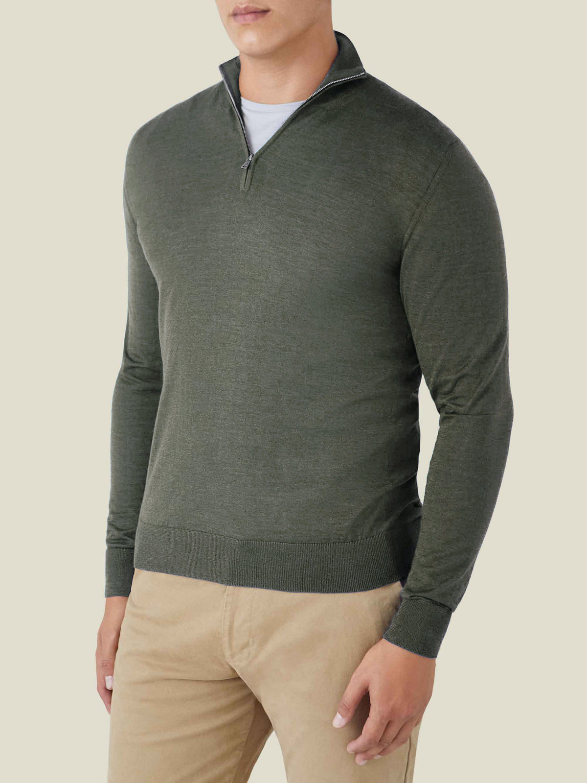 A front view of a model wearing the Luca Faloni Moss Green Silk-Cashmere Zip-up with tan trousers.