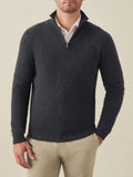 Man wearing the Luca Faloni charcoal grey cashmere zip-up over a white collared shirt and beige chinos.
